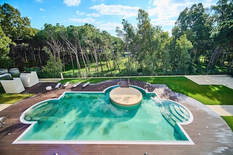 Seasonal outdoor pool, open 10:00 AM to 7:00 PM, pool umbrellas