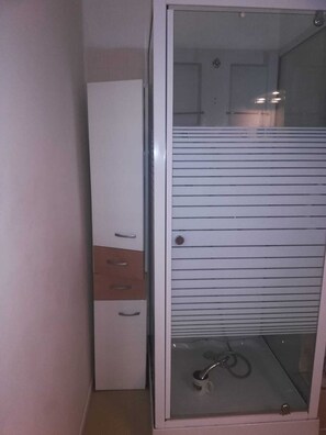 Shower, hair dryer, towels, toilet paper