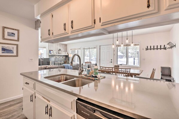 Enjoy cooking in this well-equipped kitchen with a large island and stainless steel sinks.