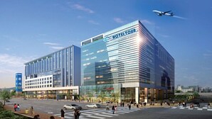 A modern hotel with a glass facade, a prominent sign for Hotel Tour, and a visible crosswalk with pedestrians. - Hotel Tour (Incheon)
