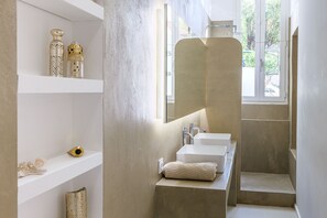 A modern bathroom with a large mirror, two sinks, and a shower area. - By the sea, a magnificent 150-square-meter apartment with a garden (Marseille)