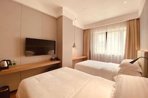 A hotel room with two beds, a TV mounted on the wall, a bedside table with a kettle, and a window with curtains. - Shenzhen Aige Hotel (Clothing Wholesale Market Nanyou Metro Station Store) (Shenzhen)