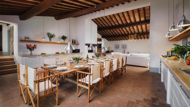 A spacious kitchen with wooden tables and chairs, a dining area, and a cozy seating area with a sofa and a bed. - Villa Carmeli 12 2 in Acquapendente (Acquapendente)