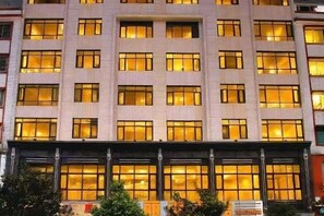 A multi-story building with a uniform facade, large windows, and a flat roof. - Ligang Hotel (Xishui)