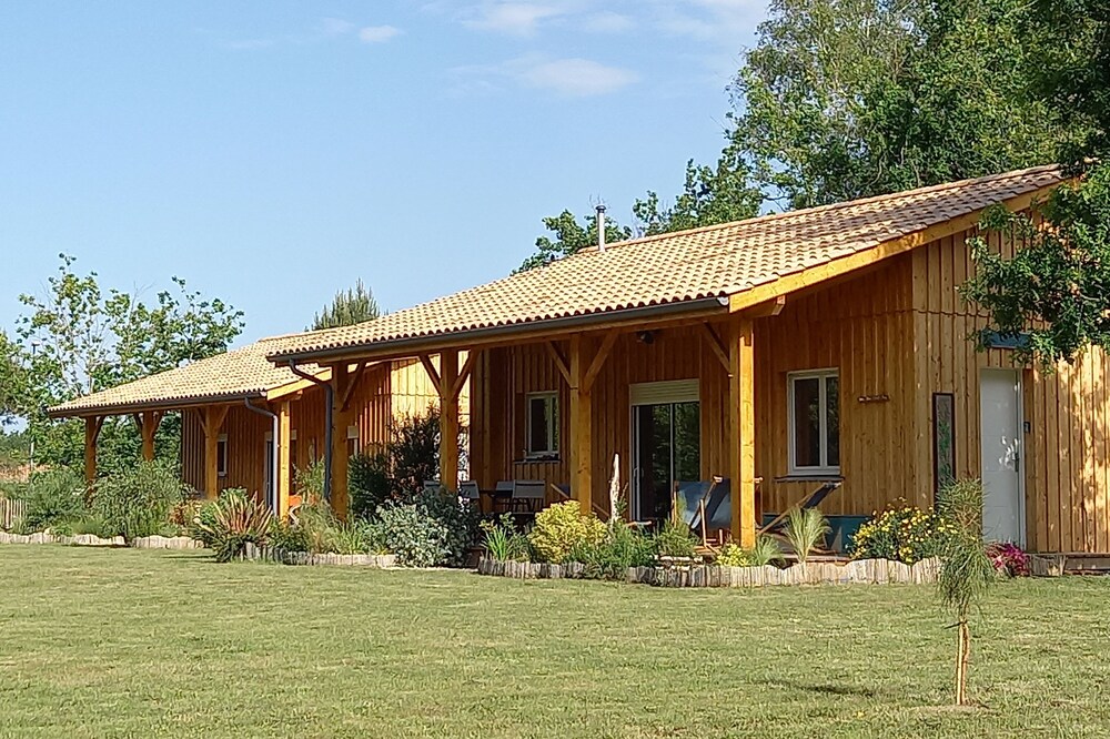 Three wooden houses with terraces near the ocean