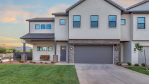 A modern two-story house with a garage, a well-maintained lawn, and a clear sky. - Oasis at Ocotillo 48, Private Pool and Spa! Ping Pong table, Nintendo Switch & Resort pool (Santa Clara)