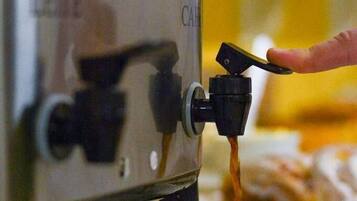A coffee machine dispensing coffee into a cup.
