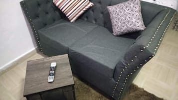 Deluxe Room | Living area | 14-inch Smart TV with digital channels, TV