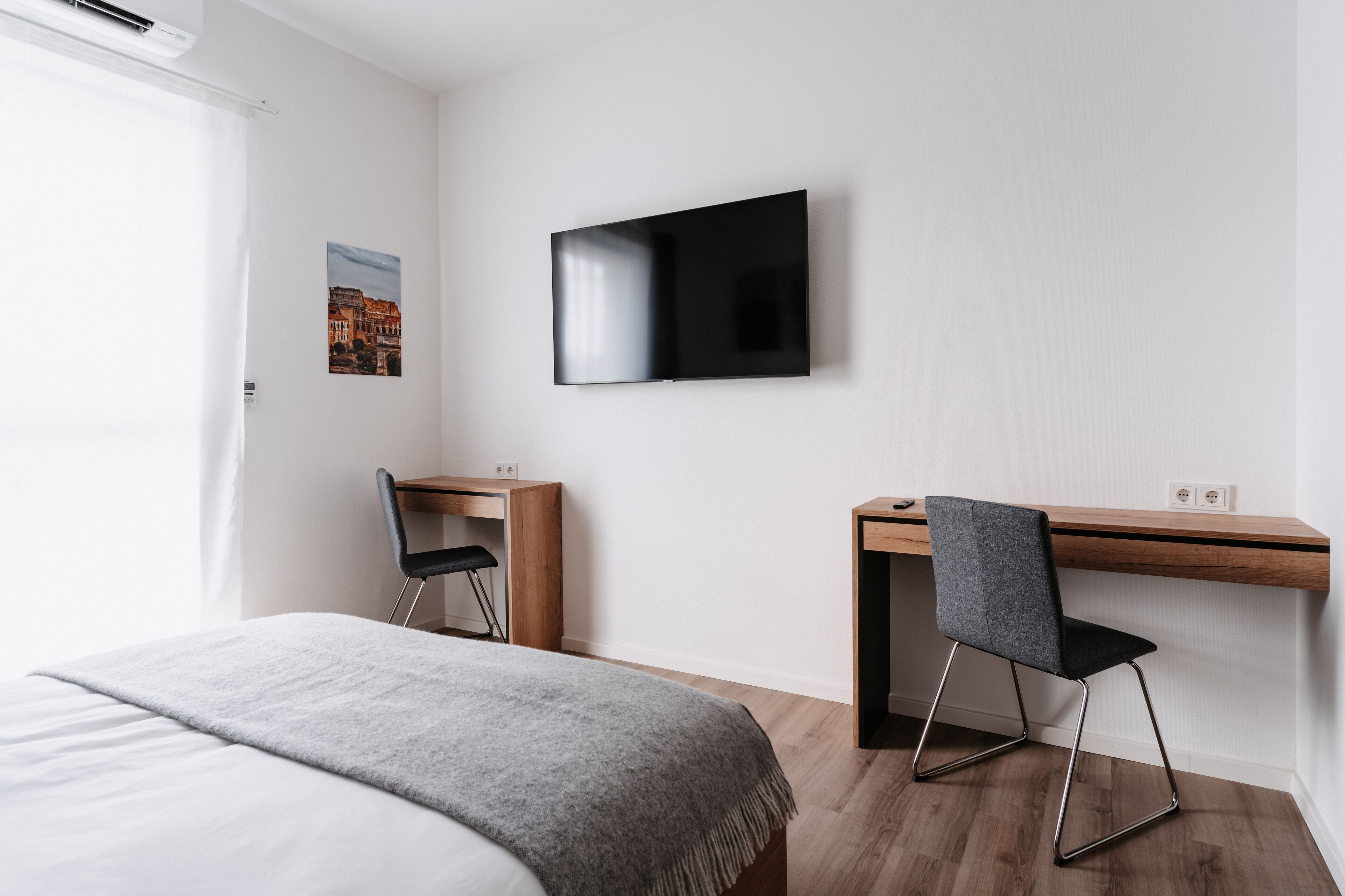 Une chambre à coucher avec un lit, un bureau et une chaise.