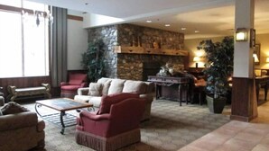 A spacious living area with a stone fireplace, comfortable seating, and a dining area. - Chic 2BR Suite on Jiminy Mtn Sleeps 8 - Gorgeous (Hancock)
