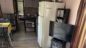 A compact living space with a kitchenette, a dining area, and a seating area.