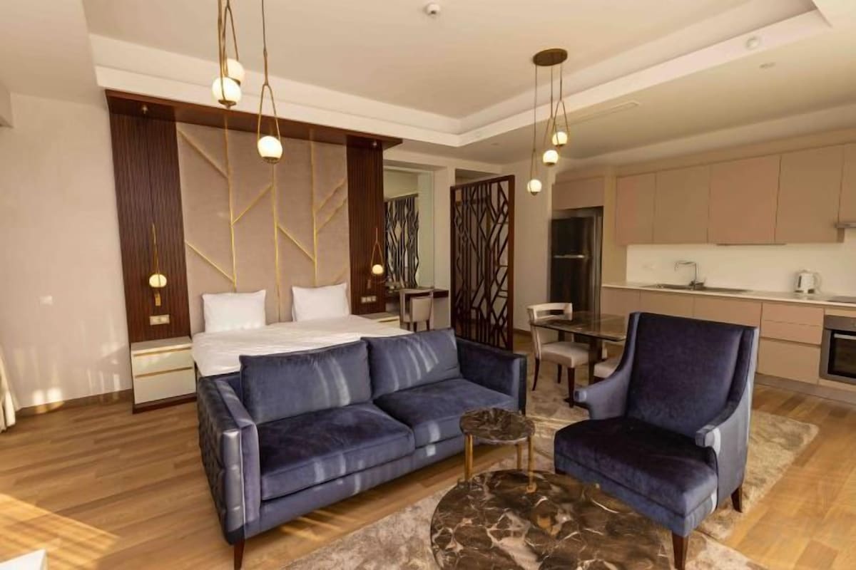 A modern living room with a sofa, armchair, and coffee table.