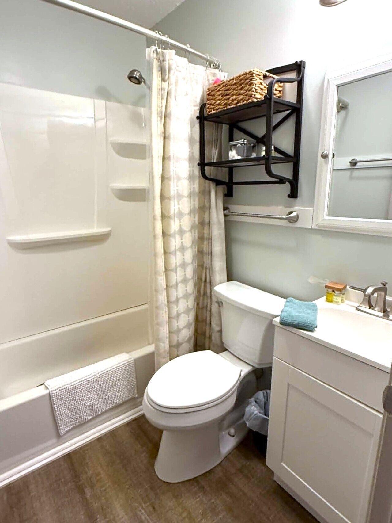 A compact bathroom with a shower, toilet, and a small sink area.