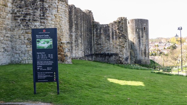 A historical site with a stone wall and a signboard detailing the English Heritage Barnard Castle. - Otters Holt (Darlington)
