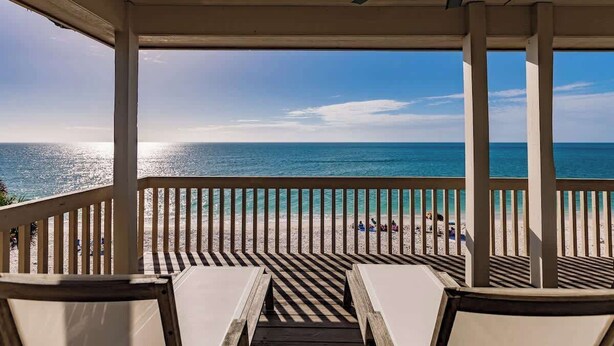 A covered outdoor area with a view of the beach and ocean. - Beachfront🌊3 KING suites & bunk room🛏️Pet Friendly🐾 (Captiva)