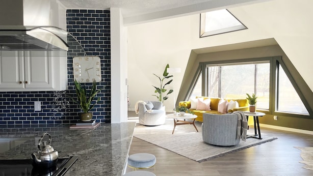 A modern kitchen with a black and white backsplash, a stainless steel kettle, and a clock on the wall. - Geo Dome - Unique Urban Getaway – one of a kind! (Springfield)