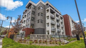Een meerhoog gebouw met balkons, met de tekst 'VITA RESORT 2555 LAKESHORE ROAD'.