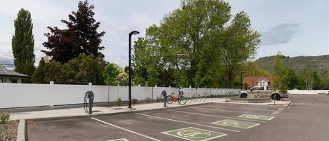 A parking lot with designated bike lanes and electric vehicle charging stations.