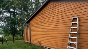 A wooden building with a metal ladder leaning against it. - Birch Point Resort Condo #19 - Nelson Lake, Hayward (Hayward)