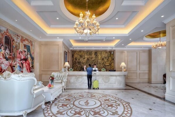 A hotel lobby with a reception desk, ornate chandeliers, and a patterned carpet. - Vienna Hotel (Shanghai Hongmei South Road) (Shanghai)