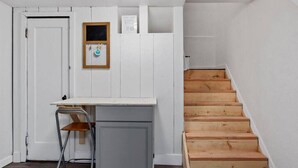A small room with a desk, chair, and a wooden staircase. - #StayinMyDistrict Twin Falls Pendleton Chic Suite (Twin Falls)