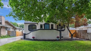 A residential house with a white exterior, a black fence, and a well-maintained lawn. - #StayinMyDistrict Twin Falls Pendleton Chic Suite (Twin Falls)