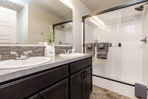 Bathtub, hair dryer, towels, shampoo