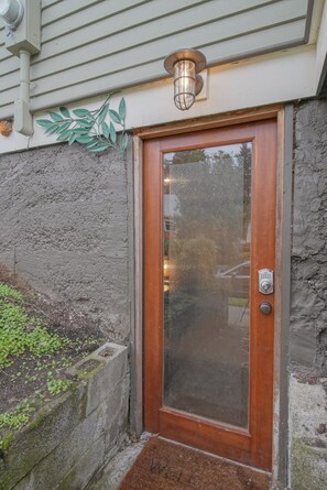 A wooden door with a glass panel and a metal doorbell. - #StayinMyDistrict Pendelton Place Walk to Mt Tabor (Portland)