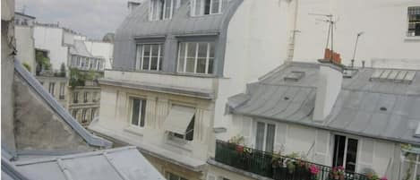 A row of European-style buildings with pitched roofs and dormer windows.