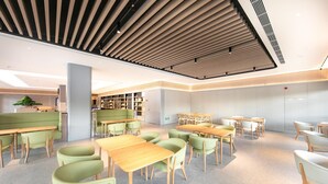 A modern library with green seating, wooden tables, and bookshelves. - Ji Hotel (Binzhou)