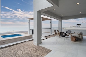 A covered outdoor area with a pool, seating, and a view of the beach. - 4 BR Luxurious Ocean front Casa Estrella in Islas del Mar (Puerto Penasco)