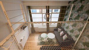A birdcage with a wooden floor, a hanging light fixture, and a window with curtains. - Canopée - Lovely studio with A/C Rhône riverbank (Lyon)