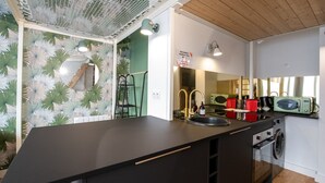 A compact kitchen with a sink, a microwave, and a washing machine. - Canopée - Lovely studio with A/C Rhône riverbank (Lyon)