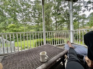 Relax in a serene outdoor seating area surrounded by lush greenery.