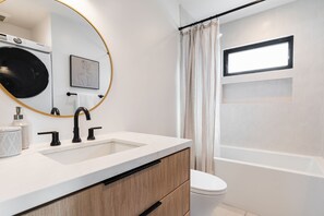 Bathtub, hair dryer, towels, soap