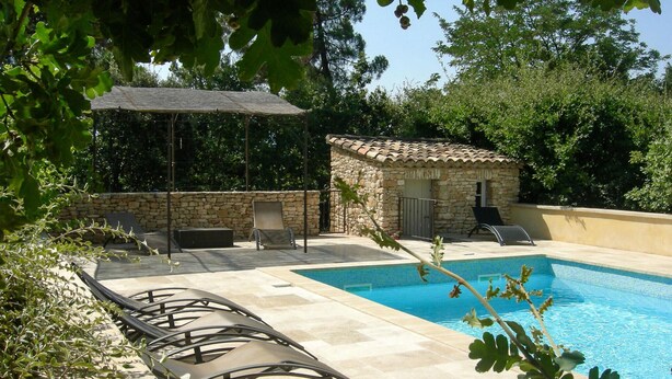 A swimming pool with lounge chairs, a stone building, and a pergola. - 2 bedroom gorgeous home in Roussillon (Roussillon)