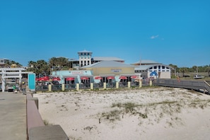 Enjoy beachfront views from the outdoor seating at Half Hitch, where you can relax with a view of the sandy beach.