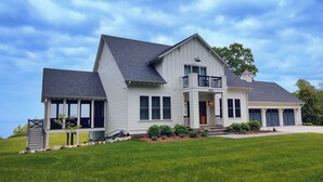 A large, single-story house with a covered porch and a garage.