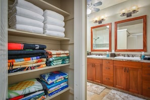 A bathroom with wooden cabinets, a sink, and a mirror.