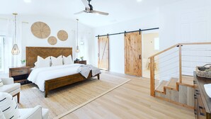 A modern bedroom with a wooden bed, a large window, and a ceiling fan. - Your wine country getaway! (Sonoma)
