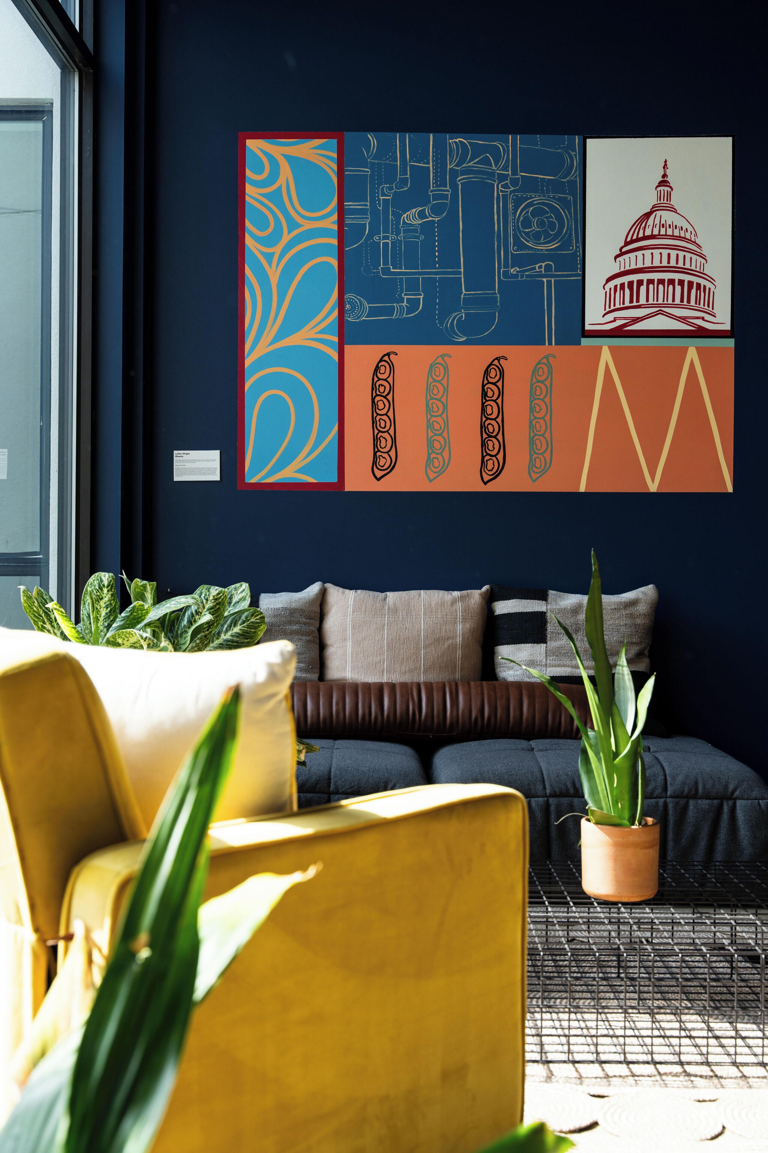 A modern living room with a sofa, a yellow armchair, and a potted plant.