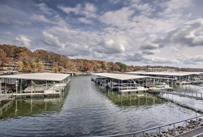 A marina with multiple docked boats and covered structures.
