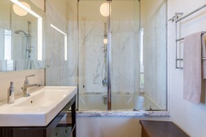 Een bad/douchecombinatie, een haardroger, een bidet, handdoeken