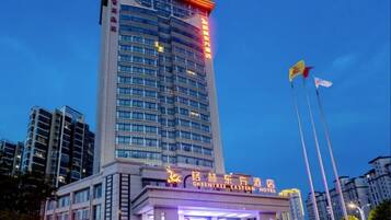 A high-rise building with a prominent sign for the GreenTree Eastern Hotel.