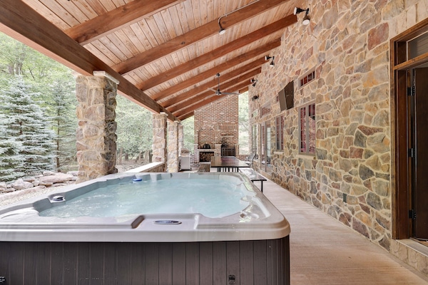 Huge hot tub on the covered stone patio