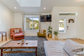 Relax in a comfortable seating area with a leather armchair and sofa, perfect for unwinding or socializing.
