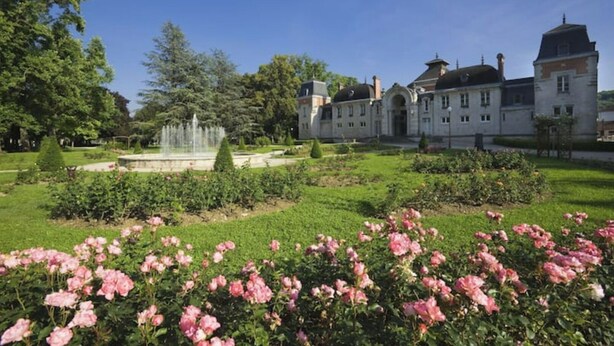 A large building with a formal garden, including a fountain and rose bushes. - App*** 2/3 pers "Nuage" ☁️ Air-conditioned with garden (Lons-le-Saunier)