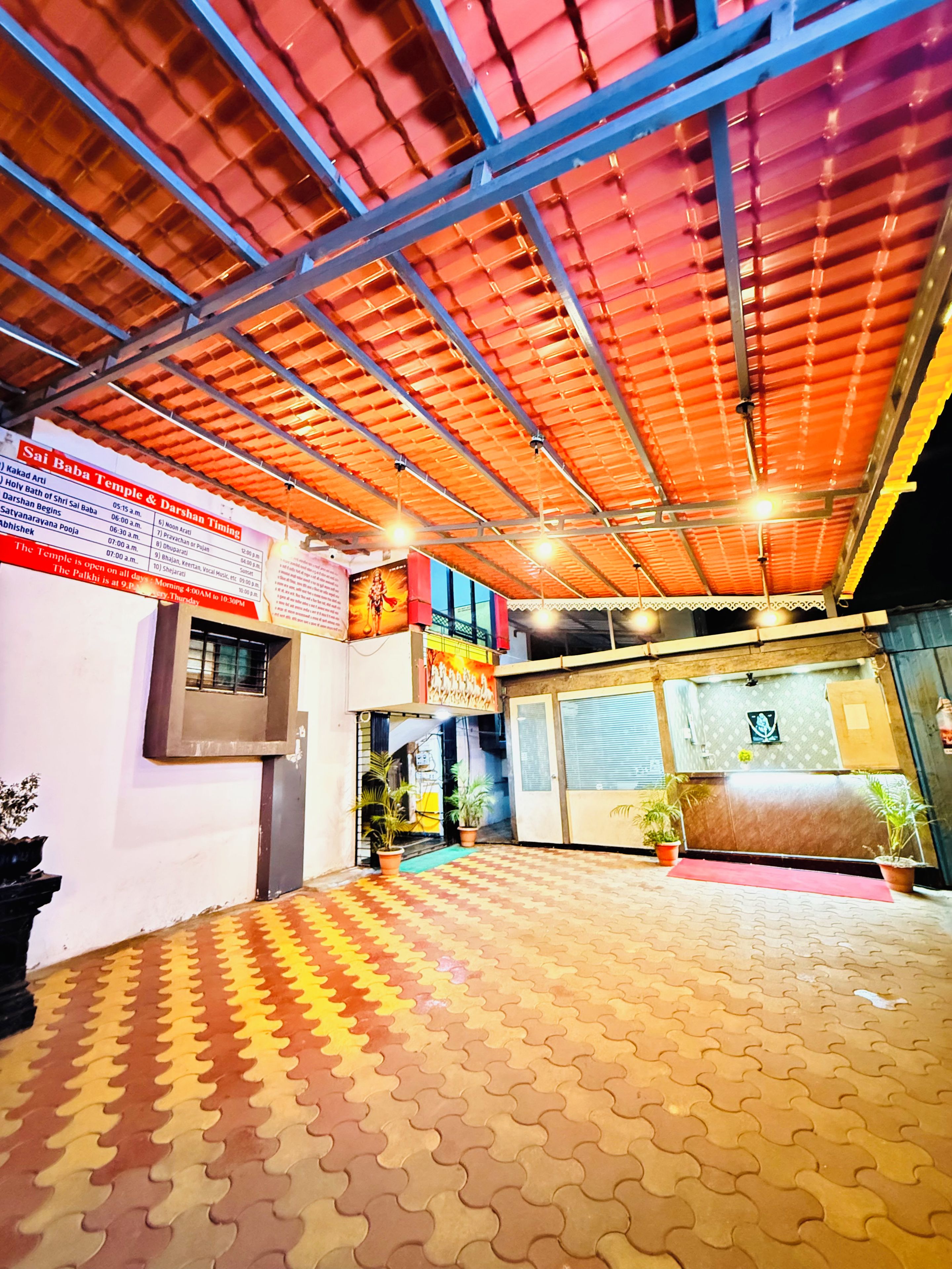 A temple with a tiled floor and a metal roof structure.