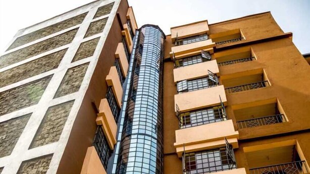 A tall building with a curved glass facade and multiple balconies. - Stay.Plus TRM Apartments (Nairobi)