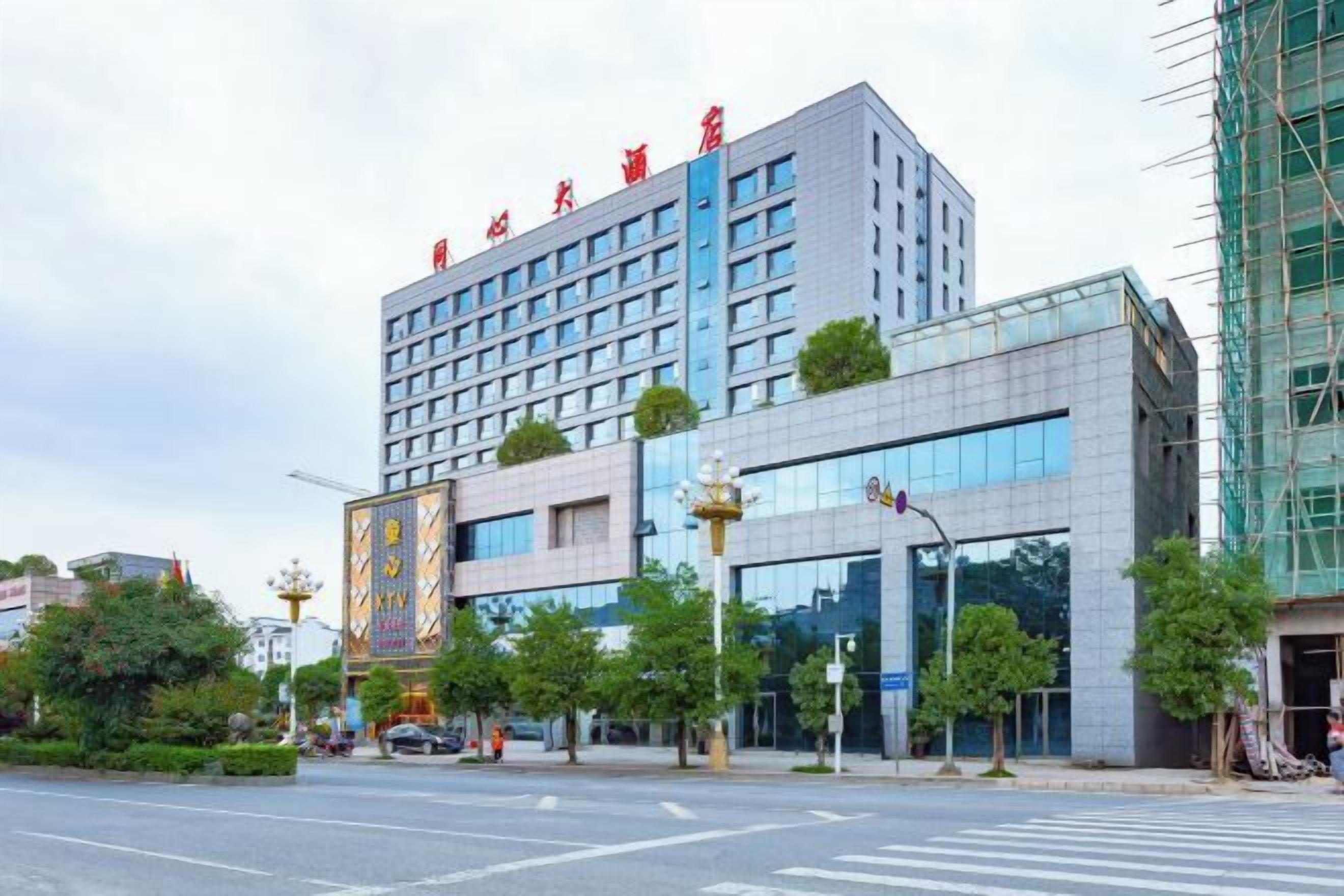 A multi-story hotel with a modern facade, large windows, and a prominent entrance.